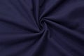 Dark blue background of fabric from a piece of crumpled clothes. Top view