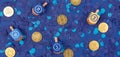 Dark blue background with multicolor dreidels and chocolate coin Royalty Free Stock Photo