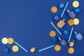 Dark blue background with multicolor dreidels and chocolate coin Royalty Free Stock Photo