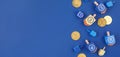 Dark blue background with multicolor dreidels and chocolate coin Royalty Free Stock Photo