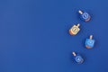 Dark blue background with multicolor dreidels. Hanukkah and judaic holiday concept. Royalty Free Stock Photo