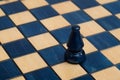 Dark blue bishop on wooden chessboard