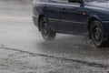 dark blue budget car moving at rainy day on asphalt road Royalty Free Stock Photo