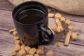 Dark blue ceramic tea mug, cookie sticks with chocolate and white icing , and pieces of brown cane sugar. Close up Royalty Free Stock Photo