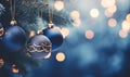 Dark blue Christmas tree decorations and festive lights in blurred bokeh background. Royalty Free Stock Photo