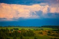 Dark blue cloudscape over green fields before storm Royalty Free Stock Photo