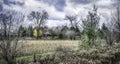 Clouds over a farmhouse and farmland in late Fall