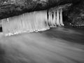 Dark blue cold water of mountain stream in winter Royalty Free Stock Photo