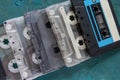 On a dark blue concrete background, there are several audio cassettes. Top view