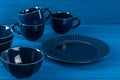 Dark blue crockery on blue wooden background