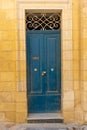 Dark blue door on an exterior brick wall Royalty Free Stock Photo