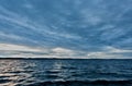 Dark blue evening cloudy sky over the lake Royalty Free Stock Photo