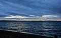 Dark blue evening cloudy sky over the lake Royalty Free Stock Photo