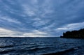 Dark blue evening cloudy sky over the lake Royalty Free Stock Photo