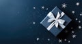 Dark blue gift box with silver satin ribbon on dark background. Top view of greeting gift with copy space for Christmas present, Royalty Free Stock Photo