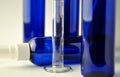 Dark blue glass bottles for cosmetic lotions, serums, oils Royalty Free Stock Photo