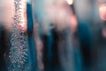 Dark blue-green background of icicles close-up. Tinted ice backdrop with winter sunset. Frozen water with air bubbles. Wallpaper Royalty Free Stock Photo