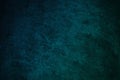 Dark blue green wall texture. Gradient. Deep teal color. Toned old rough concrete surface. Close-up. Abstract. Grunge background. Royalty Free Stock Photo