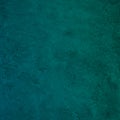 Dark blue green wall texture. Gradient. Deep teal color. Toned old rough concrete surface. Close-up. Abstract vintage background Royalty Free Stock Photo