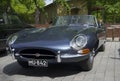 Dark blue Jaguar E-type close up in the parade of vintage cars