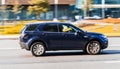 Dark blue Land Rover Discovery Sport car moving on the street on high speed