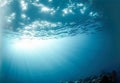 Dark blue ocean surface seen from underwater. Abstract waves underwater and rays of sunlight shining through. Generative AI Royalty Free Stock Photo