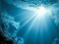 Dark blue ocean surface seen from underwater. Abstract waves underwater and rays of sunlight shining through. Generative AI Royalty Free Stock Photo