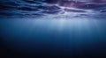 Dark blue ocean surface view from underwater with the rays of sunlight shining through Royalty Free Stock Photo