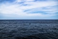 Dark blue ocean water with sunny, cloudy sky in open water in South Korea