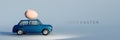 Dark blue old car with Easter egg on the roof. Easter is coming with text on blue background. Royalty Free Stock Photo