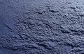 A dark blue old concrete wall has a shabby texture and is set against a background of dark blue grunge concrete Royalty Free Stock Photo