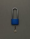 Dark blue padlock with key on a dark gray background Royalty Free Stock Photo