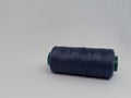 Dark blue sewing thread on isolation white background. Selective focus. Royalty Free Stock Photo