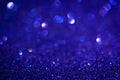 Dark blue shiny glitter texture. Selective focus. Glowing surface, sparkle lights and bokeh effects. Christmas and Royalty Free Stock Photo