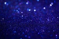 Dark blue shiny glitter texture. Selective focus. Glowing surface, sparkle lights and bokeh effects. Christmas and Royalty Free Stock Photo