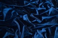 Dark blue silk satin fabric background. Delicate wavy folds. Abstract textile texture. Copy space for your design. Royalty Free Stock Photo