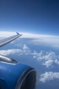 Dark Blue Sky and Clouds and an Airplane Wing and Engine Royalty Free Stock Photo