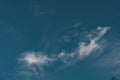 Dark blue sky with small cloud air, cloud evaporates under influence sun Royalty Free Stock Photo