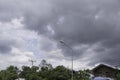 The dark blue sky with white clouds as the foreground and the sun shines on background Royalty Free Stock Photo