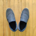 Dark blue sneaker on wood plank texture, top view Royalty Free Stock Photo