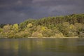 Dark blue stormy sky over river and forest. Nature before storm. Beautiful river landscape. Meteorology and weather concept. Royalty Free Stock Photo