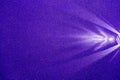 On a dark blue structural fine-grained background, a light purple scattered beam of light