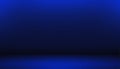 Dark Blue Studio Room with Subtle Gradient Lighting and a Soft Floor Shadow Creating an Atmospheric Background Royalty Free Stock Photo