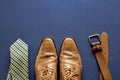 Dark blue surface with shoes. tie and a belt on the bottom Royalty Free Stock Photo