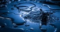 Dark blue surface with water droplets and ripples, capturing the moment of a splash. Royalty Free Stock Photo