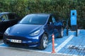 Dark blue Tesla Model Y is charging at outdoor in a charging station known as Esarj in Turkey