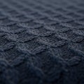 Dark blue textured fabric with a crisscross pattern creates a three-dimensional effect Royalty Free Stock Photo