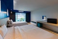 Dark blue tone interior of hotel room with sea view from window. interior room warm light style Royalty Free Stock Photo