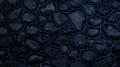 Dark blue wall made of stone and cement. Mosaic of rocks used as tiles. Toned blue stone fence. Decorative texture from