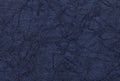 Dark blue wavy background from a textile material. Fabric with natural texture closeup.